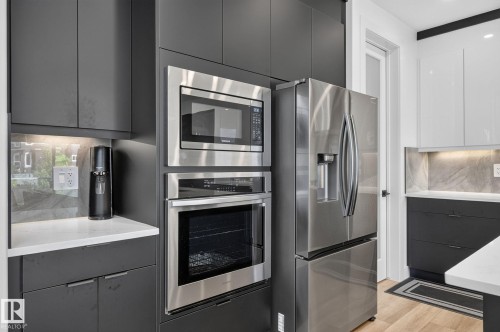 Stainless steel built-in microwave and oven combination with a coordinating stainless steel refrigerator - 16304 19 Avenue Sw, Edmonton, AB 