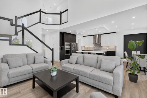Open-concept living area featuring light wood-finish flooring and recessed lighting - 16304 19 Avenue Sw, Edmonton, AB 