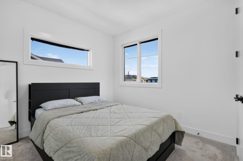 Bright room featuring carpeted flooring and white walls - 16304 19 Avenue Sw, Edmonton, AB 