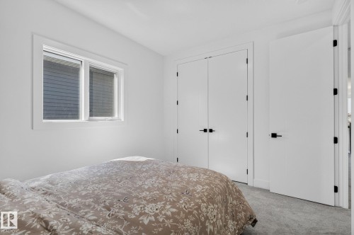 Minimalist interior featuring white walls and a light gray carpet - 16304 19 Avenue Sw, Edmonton, AB 