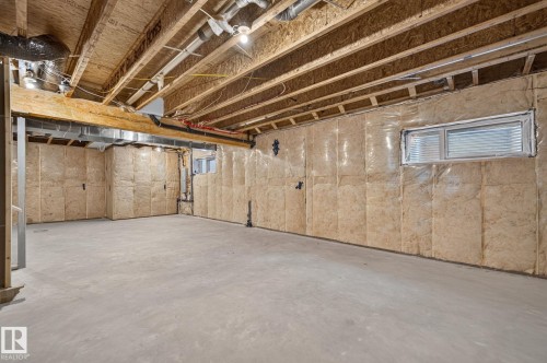 Unfinished basement featuring a concrete floor, exposed ceiling joists, and insulated walls - 16304 19 Avenue Sw, Edmonton, AB 