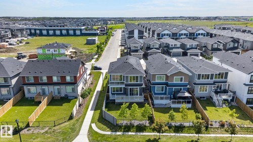 Suburban streetscape featuring diverse architectural styles, fenced backyards, and established landscaping - 16304 19 Avenue Sw, Edmonton, AB 