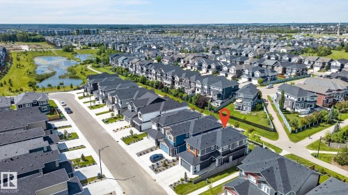 Aerial perspective of a developed residential community featuring consistent architectural styles and dark-toned roofing - 16304 19 Avenue Sw, Edmonton, AB 