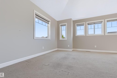 Vaulted ceiling, multiple windows, window blinds, light-toned wall paint, and carpeting - 1420 158 Street Sw, Edmonton, AB 