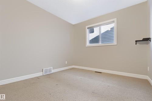 Window with horizontal blinds and white trim - 1420 158 Street Sw, Edmonton, AB 