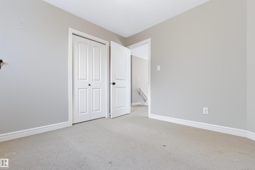 Light-toned walls, neutral carpet flooring, and white trim - 1420 158 Street Sw, Edmonton, AB 