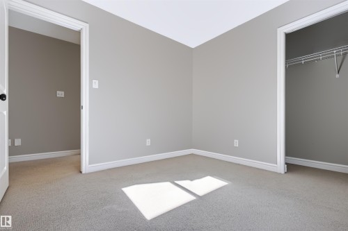 Gray wall finish, white trim, and light-toned carpeting - 1420 158 Street Sw, Edmonton, AB 
