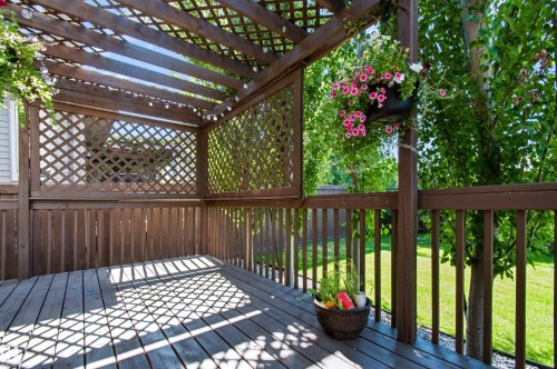 Wood deck with open pergola, lattice privacy screens, and wood railings - 1420 158 Street Sw, Edmonton, AB 