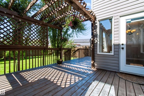 Wood-finish deck with a lattice pergola - 1420 158 Street Sw, Edmonton, AB 