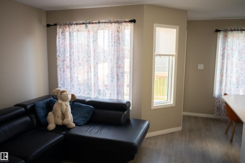 Contemporary interior with neutral wall tones and wood-finish flooring - 9014 Cooper Link Link Sw, Edmonton, AB 