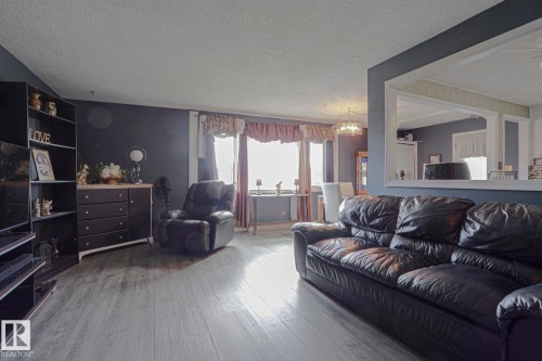 Wood-finish flooring throughout the living area - 11440 144 Avenue Nw, Edmonton, AB 