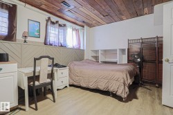 Wood-finish ceiling, light wood-finish flooring, built-in shelving, white paneled wainscoting, and multiple windows - 
