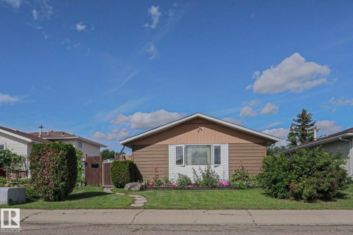 Gable roofline with light fascia, horizontal siding, and a prominent front window - 11440 144 Avenue Nw, Edmonton, AB 