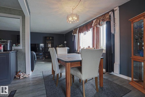 Wood-finish flooring throughout the dining area and adjacent space - 11440 144 Avenue Nw, Edmonton, AB 