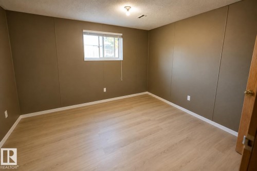 Light wood-finish flooring, recessed window, and a flush mount ceiling light fixture - 14707 33 Street Nw, Edmonton, AB 