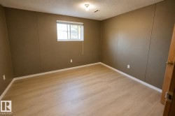 Light wood-finish flooring, recessed window, and a flush mount ceiling light fixture - 