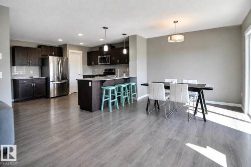 Open-concept living area with wood-finish flooring - 4847 173 Avenue Nw, Edmonton, AB 