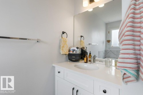 White vanity with black hardware, under-mount sink, and a chrome faucet - 34 Raspberry Road, St. Albert, AB 
