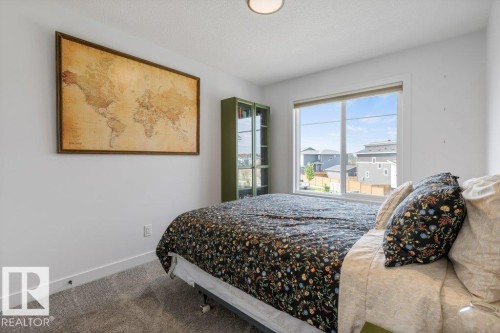 Window with horizontal blinds, flush mount ceiling fixture, and carpet flooring - 34 Raspberry Road, St. Albert, AB 