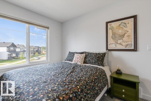 White walls, large window, and light-toned carpet - 34 Raspberry Road, St. Albert, AB 