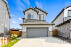 Two-story contemporary exterior with a single-car garage, concrete driveway, and stone accents - 