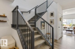 Split-level staircase with carpeted treads and dark-toned balusters - 