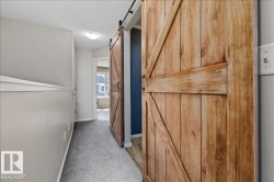 Barn door entry to a room with dark accent wall - 
