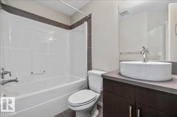 Full bathroom featuring a white tub/shower combination with chrome fixtures - 