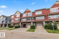 Townhouse row with red horizontal siding and light trim - 