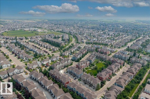 Aerial perspective of a developed residential area featuring a mix of detached homes and townhouses - #31 603 Watt Bv Sw, Edmonton, AB - Outdoor With View