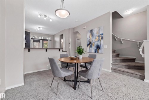 Dining area featuring neutral wall tones and grey carpeting - #31 603 Watt Bv Sw, Edmonton, AB - Indoor Photo Showing Dining Room
