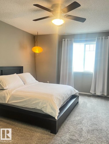 Neutral-toned walls complement plush carpeting - 5001 62 Street, Beaumont, AB 