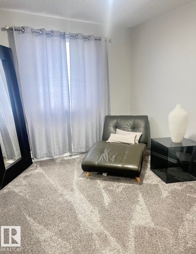 Neutral tone carpeting throughout the space - 5001 62 Street, Beaumont, AB 
