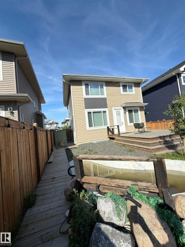 Two-story exterior with multi-toned siding, tiered rear deck, and fenced perimeter - 20827 130 Avenue Nw, Edmonton, AB 