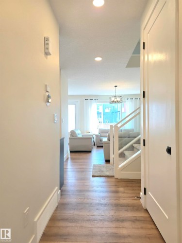 Wood-finish flooring throughout the main level - 20827 130 Avenue Nw, Edmonton, AB 