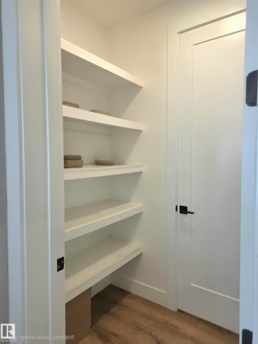 Built-in shelving, wood-finish flooring, white doors, and black hardware - 20827 130 Avenue Nw, Edmonton, AB 