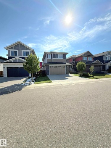 Two-story residence with a two-car garage, concrete driveway, and front lawn - 20827 130 Avenue Nw, Edmonton, AB 