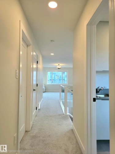Recessed ceiling lighting illuminating a carpeted hallway with white interior doors featuring matte black hardware - 20827 130 Avenue Nw, Edmonton, AB 