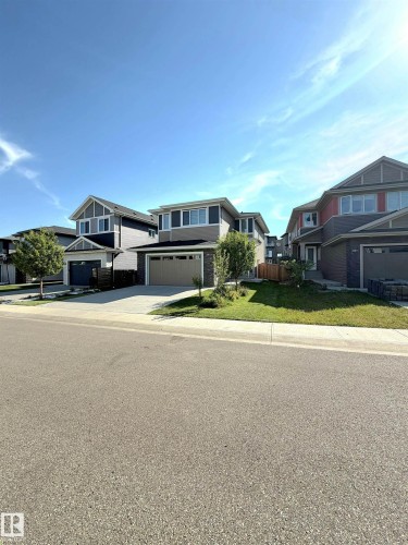 Two-story residence featuring a two-car garage, stone accents, and a sloped front yard - 20827 130 Avenue Nw, Edmonton, AB 