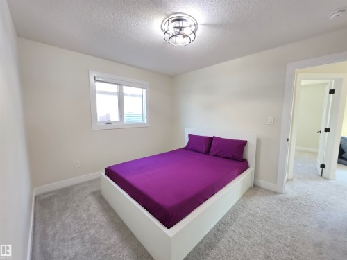 Neutral wall colors, white trim, recessed window, flush-mount light fixture, and light-colored carpet - 20827 130 Avenue Nw, Edmonton, AB 