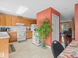 Kitchen featuring wood-finish cabinetry, white countertops, and tile flooring - 