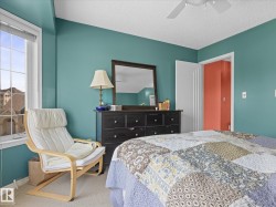 Bedroom featuring teal walls and a white textured ceiling - 