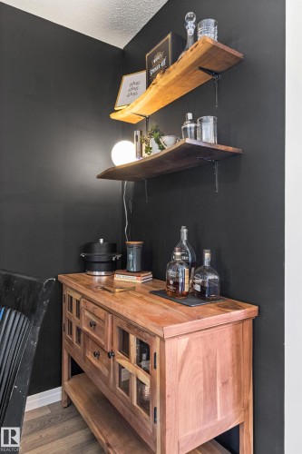 Wood-finish open shelving with metal brackets - 4306 Prowse Link Link Sw, Edmonton, AB 