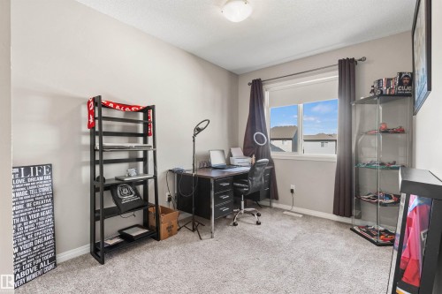 Carpeted flooring, neutral wall color, and a window with a roller shade - 4306 Prowse Link Link Sw, Edmonton, AB 
