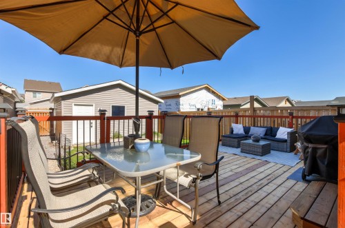 Expansive wood deck with a privacy fence, featuring a detached garage with vinyl siding - 4306 Prowse Link Link Sw, Edmonton, AB 