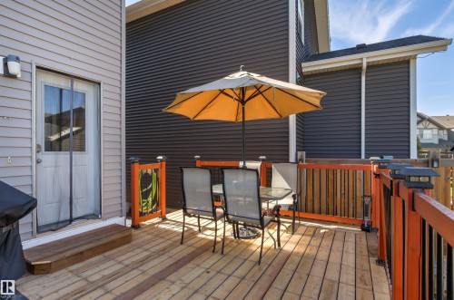 Spacious wood deck with perimeter railing and integrated post lighting - 4306 Prowse Link Link Sw, Edmonton, AB 