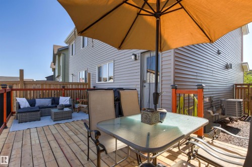 Expansive outdoor deck with wood flooring and a wooden privacy fence - 4306 Prowse Link Link Sw, Edmonton, AB 
