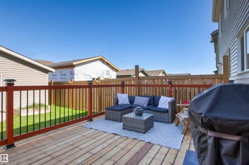 Spacious wood deck with contrasting dark and red railing - 4306 Prowse Link Link Sw, Edmonton, AB 