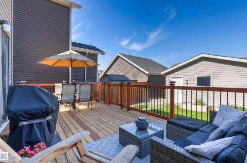 Spacious wood deck with dark brown and black railings - 4306 Prowse Link Link Sw, Edmonton, AB 