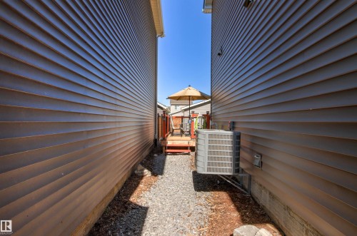 Gravel pathway leading to a wood deck with railings and steps - 4306 Prowse Link Link Sw, Edmonton, AB 